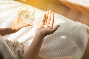 Woman holding a pill