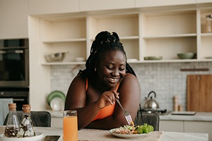 a woman eating lunch in her kitchen