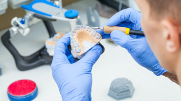 Lab technician carving dentures