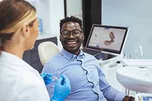 Patient in Springfield smiling after getting dental implants