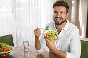 Patient in Springfield eating after getting dental implants