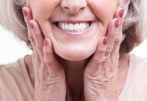 Smiling woman with her hands on her cheeks